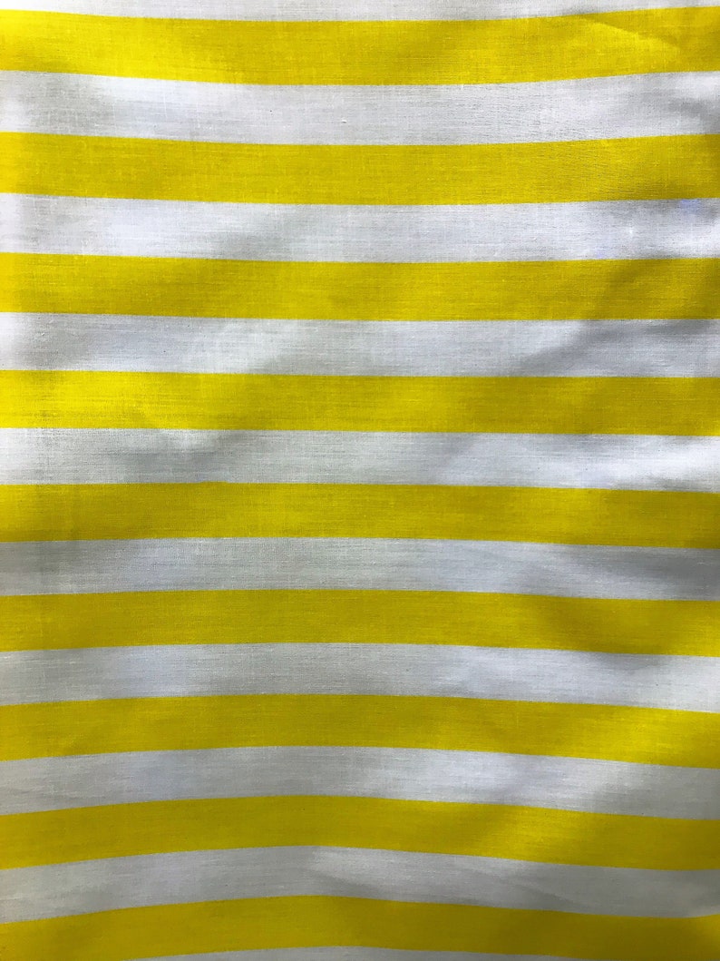 May include: Yellow and white striped fabric with a subtle texture. The fabric is folded and has a slight wave pattern.