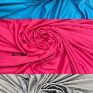 May include: Three fabric swatches in turquoise, hot pink, and gray. The fabric is smooth and has a slight sheen.