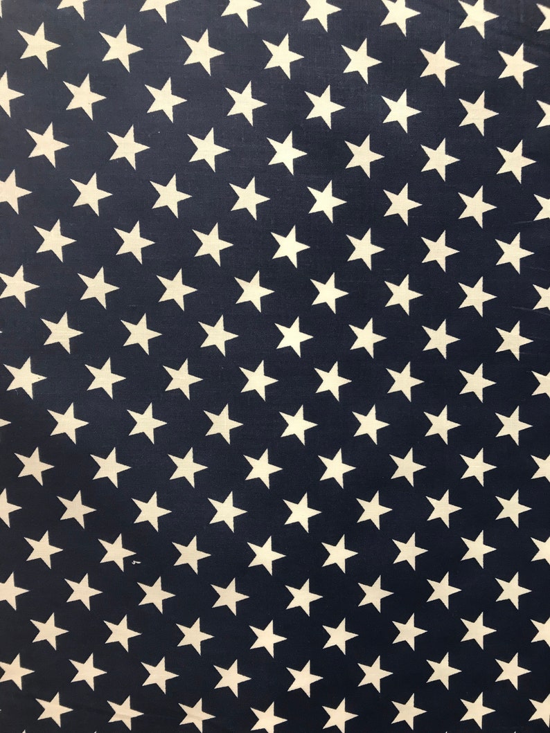 May include: A navy blue fabric with a repeating pattern of white stars. The stars are arranged in diagonal rows.