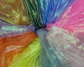 May include: A collection of iridescent sheer fabrics in a rainbow of colours, including yellow, orange, pink, blue, green, and purple.
