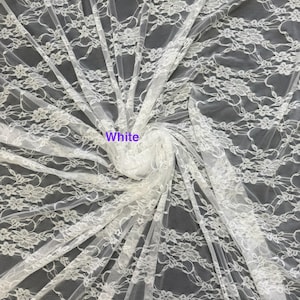 May include: A sheer white lace fabric featuring a repeating floral pattern with delicate scalloped edges and intricate mesh detailing. The fabric is gathered in the center, displaying the lightweight texture and the word White printed on it.