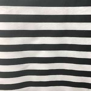 May include: Black and white striped fabric with a subtle wave pattern.