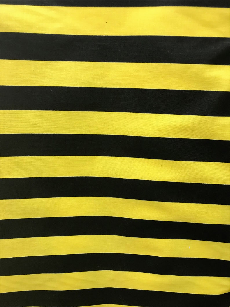 May include: Yellow and black striped fabric. The fabric has a smooth, shiny texture.