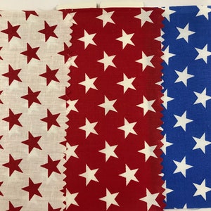 May include: Three fabric swatches with a white star pattern on different colored backgrounds. The swatches are white with red stars, red with white stars, and blue with white stars.