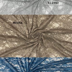 May include: Three swatches of floral lace fabric arranged in a vertical stack. The top section is silver, the middle section is labeled Mocha, and the bottom section is labeled Teal. Each piece of fabric features a delicate, intricate floral pattern.