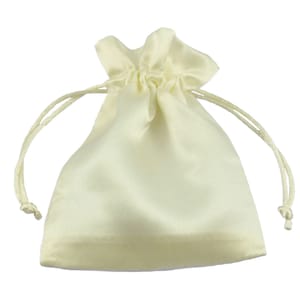 May include: A small, ivory-colored satin drawstring bag with a gathered top. The bag is empty and has a smooth, silky texture.