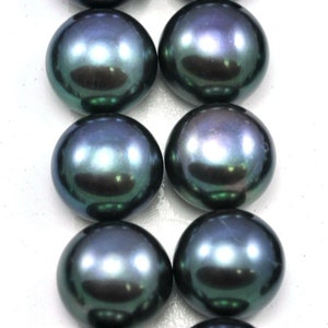May include: A row of dark green and black round pearls with iridescent sheen.