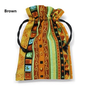 May include: A brown drawstring bag with a colourful geometric pattern. The bag is made of fabric and has a black drawstring.