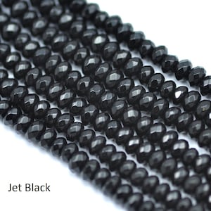 May include: Jet black faceted beads, a strand of black gemstone beads, black beads for jewellery making.