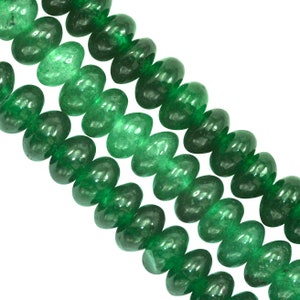 May include: A strand of green jade donut beads. The beads are smooth and polished, with a slightly translucent appearance.