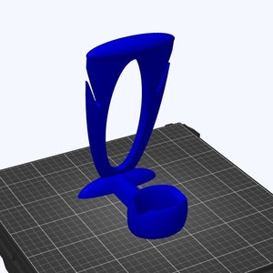 May include: A blue plastic phone stand with a curved design. The stand has a circular opening at the top and a small base.