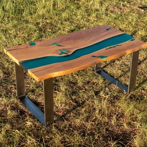 Live edge river oak coffee table with glowing resin fillin and natural turquoise stone