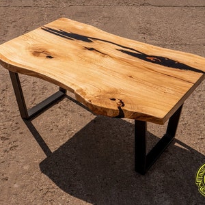 Live edge oak coffee table with black resin , black powder painted legs, rustical oak