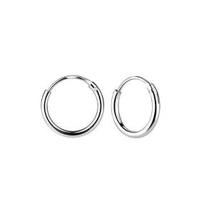May include: A pair of silver hoop earrings. The earrings are small and simple, with a smooth finish.