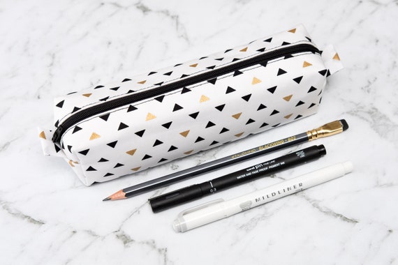 white and gold pencil case
