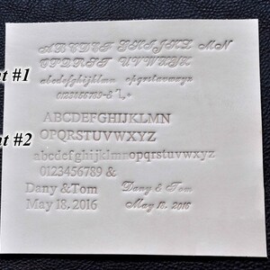May include: A white card with two different fonts displayed. The first font is a cursive script font and the second font is a block font. The card also includes the text "Dany & Tom" and "May 18, 2016".