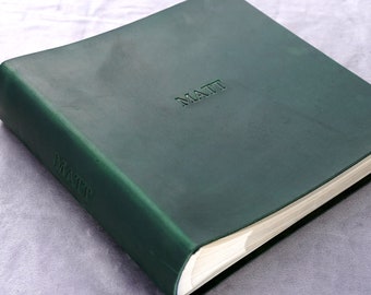 May include: A dark green leather-bound journal with the name "MATT" embossed on the front cover.