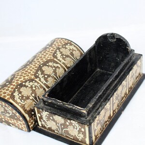 May include: An open, decorative wooden box with a matching lid. The box and lid are painted with a repeating pattern of beige leaves and brown dots on a cream background. The interior of the box is black.