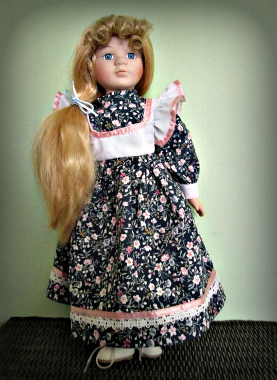 porcelain doll with blonde hair and blue eyes
