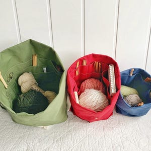 Gift for knitters! Organic canvas knitting bag/organizer with numerous pockets to hold all your supplies. Portable & eco-friendly. 3 sizes.