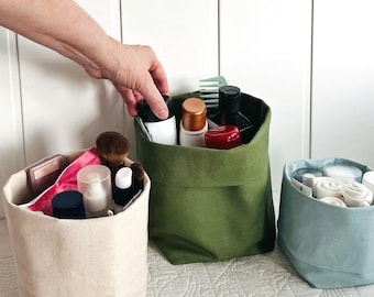 Organic cotton upright makeup, skincare and toiletries organizer. Home bath and travel bag with many pockets.  Vertical storage for liquids.