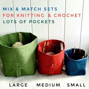 May include: Three fabric storage containers in green, red, and blue, labeled Large, Medium, and Small. The containers have multiple pockets and are designed for knitting and crochet supplies. Text at the top reads "MIX & MATCH SETS FOR KNITTING & CROCHET LOTS OF POCKETS."