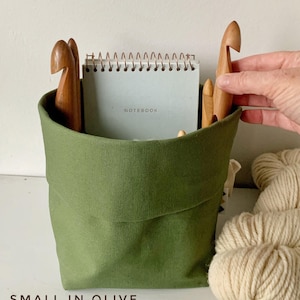 May include: A set of three ceramic mugs with a speckled, matte finish. The mugs are in shades of cream, light gray, and dark gray. Each mug has a simple, minimalist design, perfect for coffee or tea.