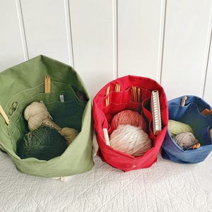 Gift for knitters! Organic canvas knitting bag/organizer with numerous pockets to hold all your supplies. Portable & eco-friendly. 3 sizes.