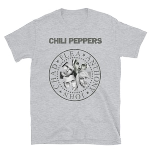 May include: A gray t-shirt with the words "Chili Peppers" printed in black at the top. Below the text is a circular design with the names "Chad", "Flea", "Anthony", and "John" printed around the edge. The center of the circle features black and white images of the band members.