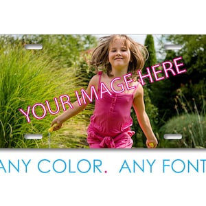 May include: A personalized license plate with a photo of a young girl in a pink dress, jumping in a grassy field. The text "YOUR IMAGE HERE" is superimposed on the image.