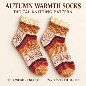 May include: A pair of knitted socks featuring a multi-coloured pattern in cream, orange, and burgundy with a scalloped cuff. The text reads: AUTUMN WARMTH SOCKS DIGITAL KNITTING PATTERN, PDF + WORD, ENGLISH, 24 cm foot, EU 38-38.5.