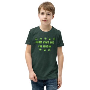 May include: A dark green t-shirt with the text "HIGH FIVE ME, I'M IRISH!" in bright green. The shirt features various green icons, including a laptop, sun, and rainbow. The shirt is worn by a person.