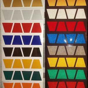 May include: A set of ten reflective vinyl decals in various colors, including gold, silver, red, blue, black, yellow, green, and orange. Each decal features a repeating pattern of five chevron shapes.