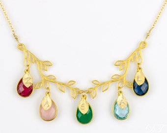 May include: Gold necklace with a delicate branch design and five teardrop-shaped gemstones in various colors, including red, pink, green, and blue.