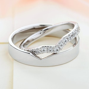 Beautiful matching wedding bands with diamonds in her ring. Unique wedding bands.