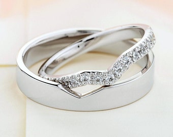 Beautiful matching wedding bands with diamonds in her ring. Unique wedding bands.