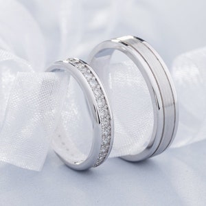 Couple wedding rings set with diamonds in her ring. Matching wedding bands. His and hers wedding rings set. Solid gold wedding bands.