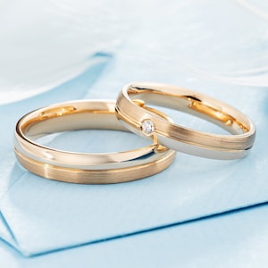 Classic gold wedding bands with diamond in her ring. Couple wedding bands. His and hers wedding rings set. Matching wedding bands.
