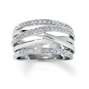 May include: A silver ring with multiple bands, each set with small diamonds.