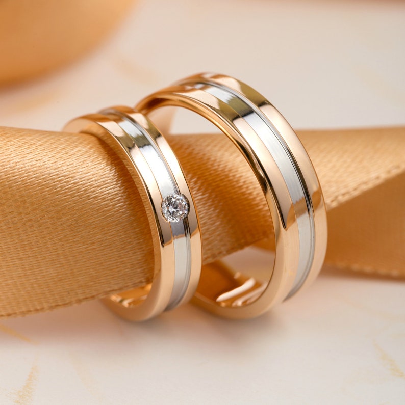 Matching wedding bands made of two colors of gold.