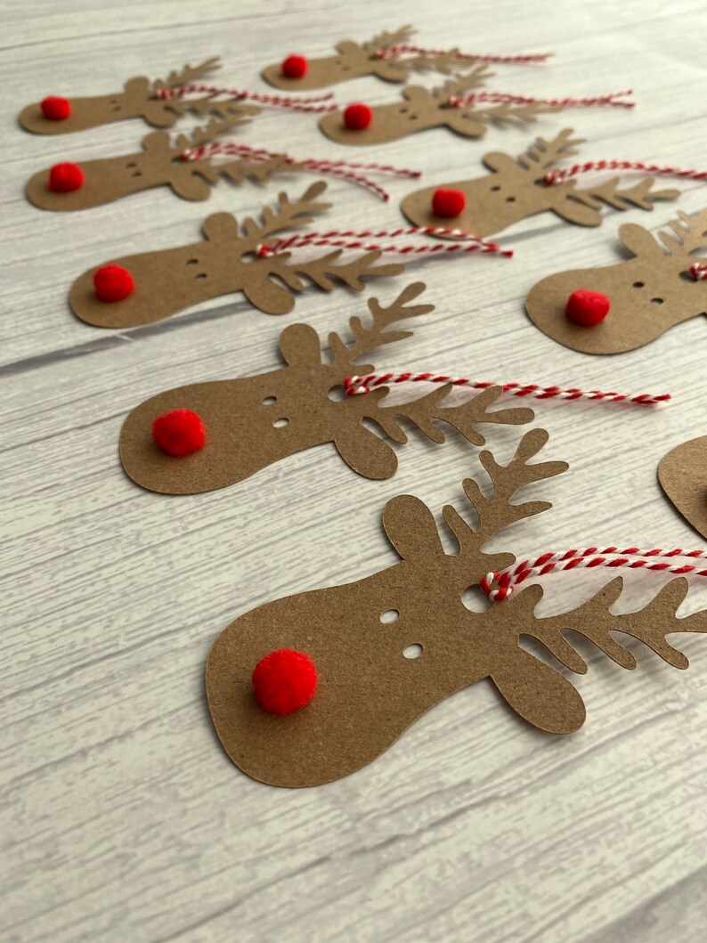 May include: A set of ten brown paper reindeer gift tags with red pom-poms for noses and red and white twine.