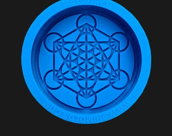 May include: Blue silicone mold with a raised geometric design of a flower of life pattern. The mold is circular and has the text "MET6014V1" and "WWW.PHIMOLD.COM" on the edge.