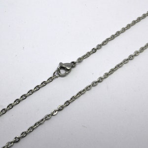 May include: A silver chain necklace with a lobster clasp.