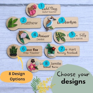 May include: Eight wooden name tags with different designs and names. Each tag has a small decorative element, such as a flower, bird, or plant. The tags are numbered 1 through 8. Choose your designs.