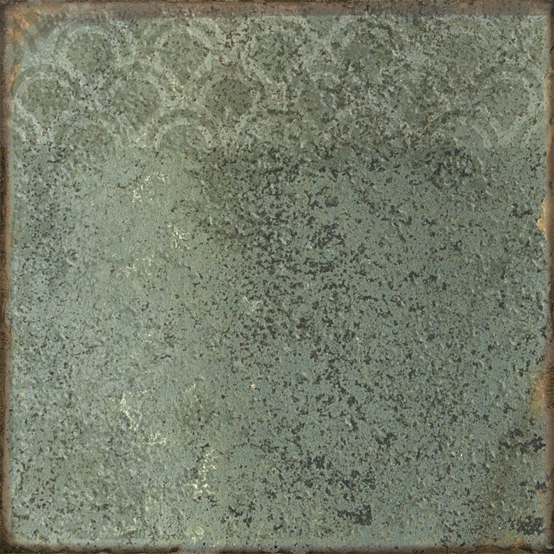 May include: A square ceramic tile with a weathered, textured surface in shades of sage green and dark gray. The top section features a faint, repeating scalloped pattern, while the edges show a dark, rusted brown border with a distressed finish.