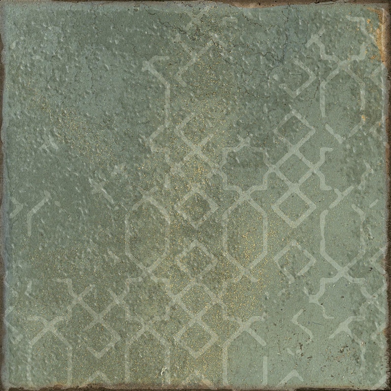 May include: A square tile with a textured, sage green surface featuring a faint, repeating geometric pattern of interlocking diamonds and elongated hexagons in a lighter, muted tone. The edges of the tile appear slightly worn and dark.