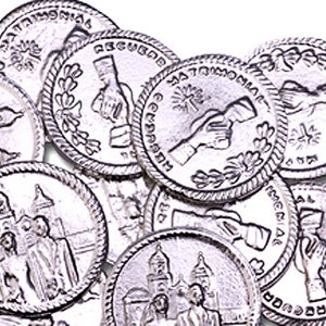 May include: A collection of silver-toned metal tokens with various designs. Some tokens feature a building with a dome, while others depict two hands shaking. The tokens have a raised rim and a smooth surface.