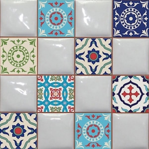 May include: A set of 12 decorative ceramic tiles featuring intricate geometric patterns in shades of blue, green, red, and white. The tiles are arranged in a grid pattern, creating a visually appealing mosaic.