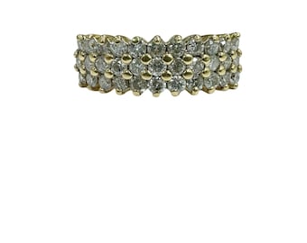 May include: A gold band ring with a multi-row design of small, round, clear diamonds.