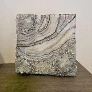Cosmic geode that holds the secrets of the universe, Silver, crystals and subtle shine that evoke the connection with the internal
